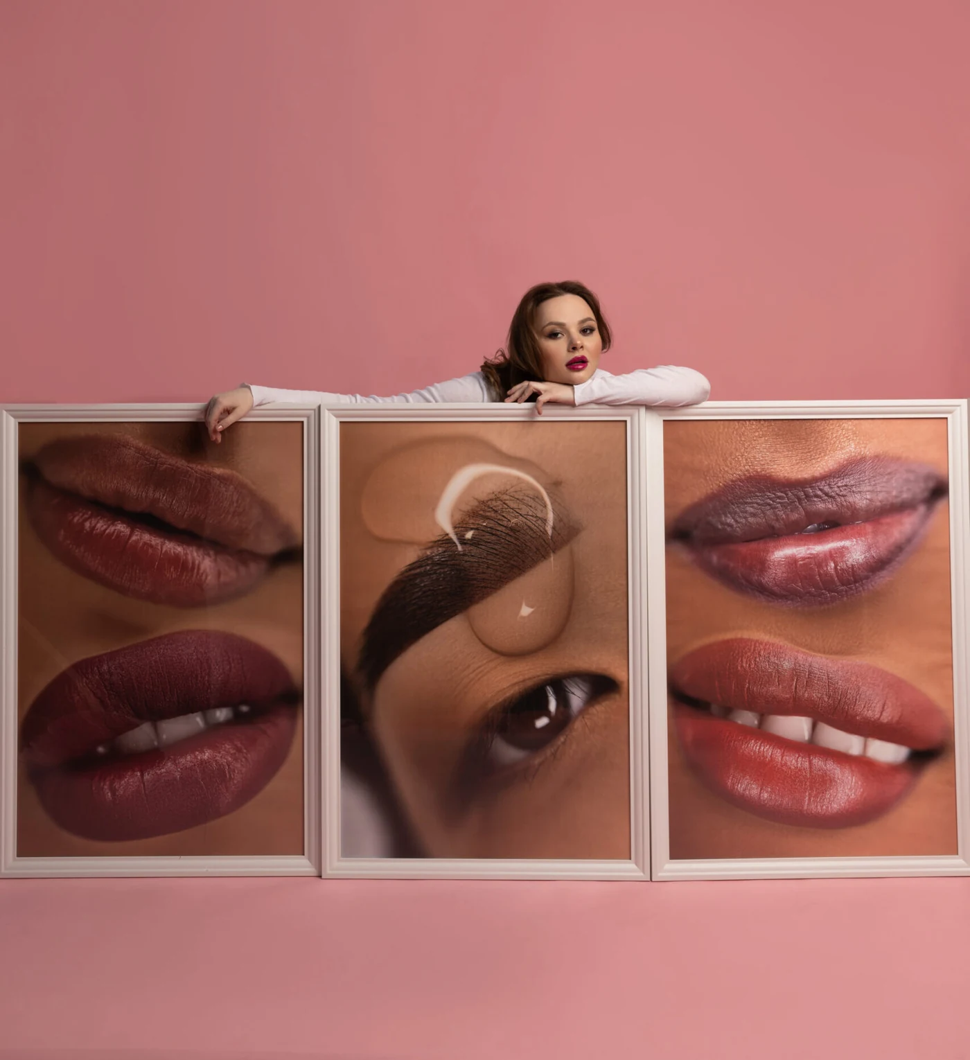 Elina behind framed photographs of brow and lip results